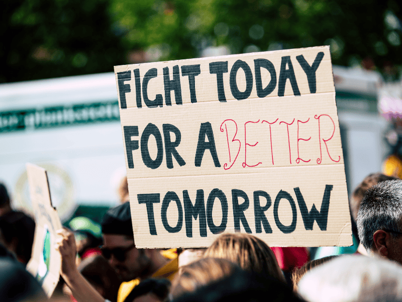 A group of people holding a sign